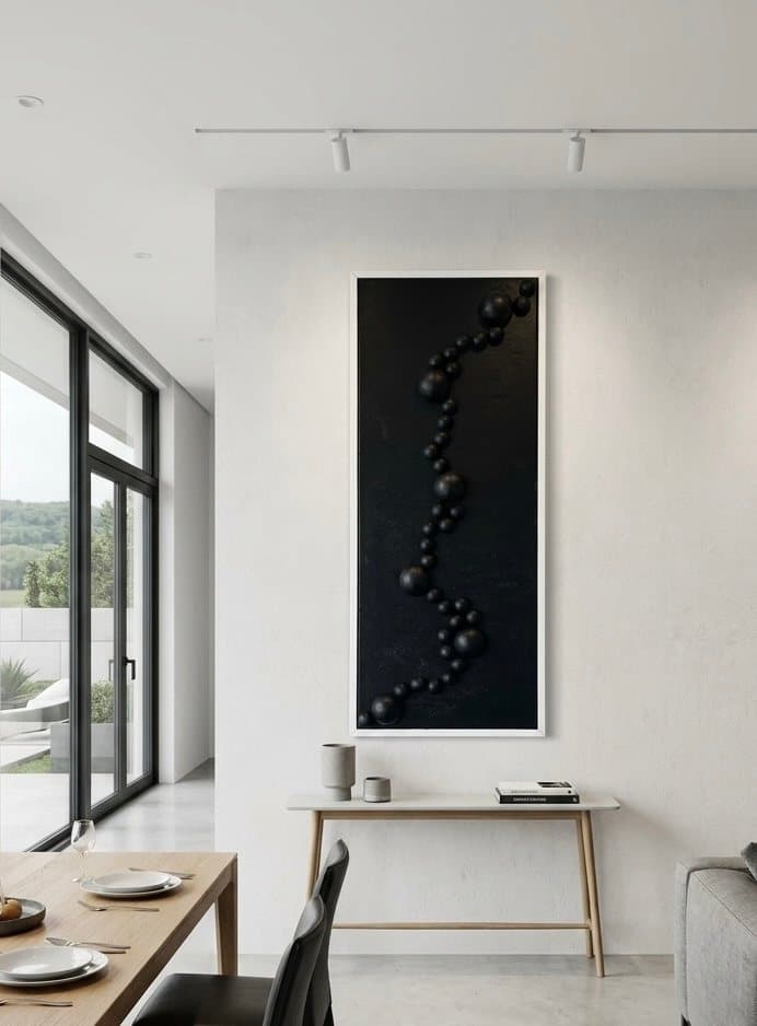 Tall dark panel with a chain of black three-dimensional spheres in relief.