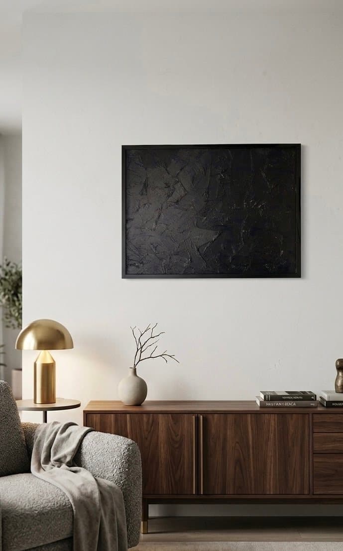 Black textured abstract painting, troweled plaster catching light across the surface.